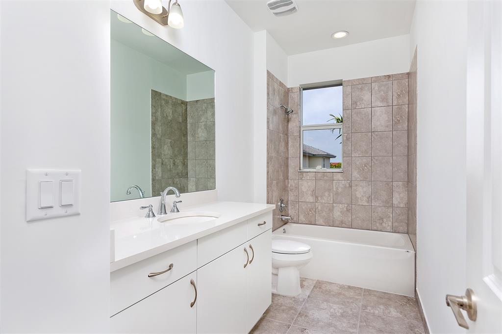 6947 Pines Circle, Unit 21 Pompano Beach, FL 33073 - Photo 19 of 31 a bathroom with a double vanity sink a toilet a bathtub and shower