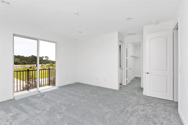 a view of a wooden deck and lake from a balcony