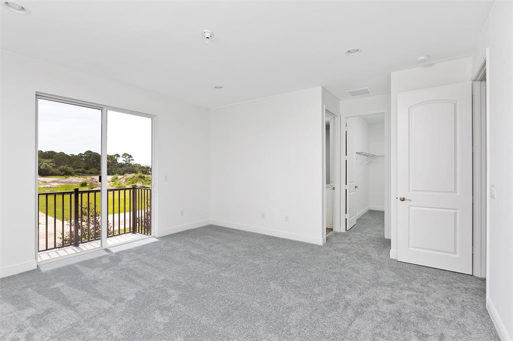 6947 Pines Circle, Unit 21 Pompano Beach, FL 33073 - Photo 20 of 31 an empty room with sliding door and mountain view