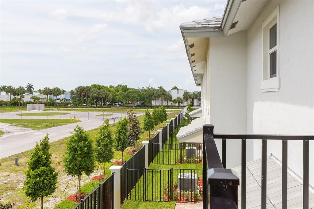 6947 Pines Circle, Unit 21 Pompano Beach, FL 33073 - Photo 22 of 31 a view of a wooden deck and lake from a balcony