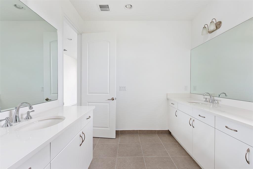 6947 Pines Circle, Unit 21 Pompano Beach, FL 33073 - Photo 24 of 31 a spacious bathroom with 2 sink and a mirror