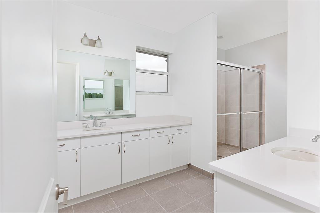 6947 Pines Circle, Unit 21 Pompano Beach, FL 33073 - Photo 25 of 31 a bathroom with a sink and a mirror