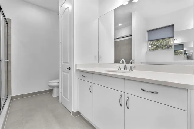 a bathroom with a sink toilet and shower