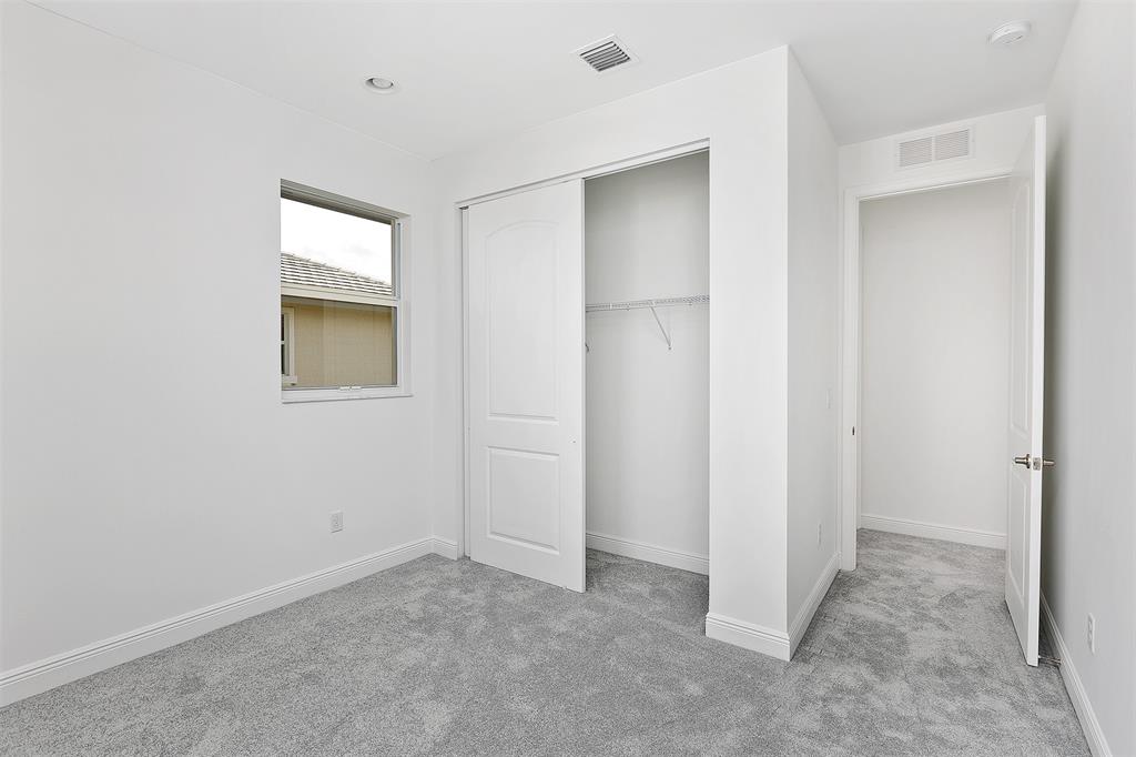 6947 Pines Circle, Unit 21 Pompano Beach, FL 33073 - Photo 28 of 31 an empty room with windows and closet