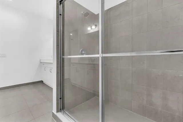 a bathroom with a glass shower door