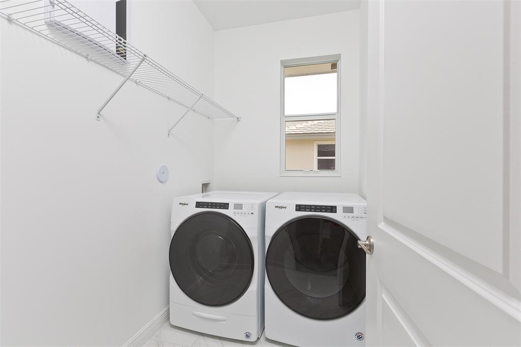 6947 Pines Circle, Unit 21 Pompano Beach, FL 33073 - Photo 30 of 31 a utility room with dryer and washer