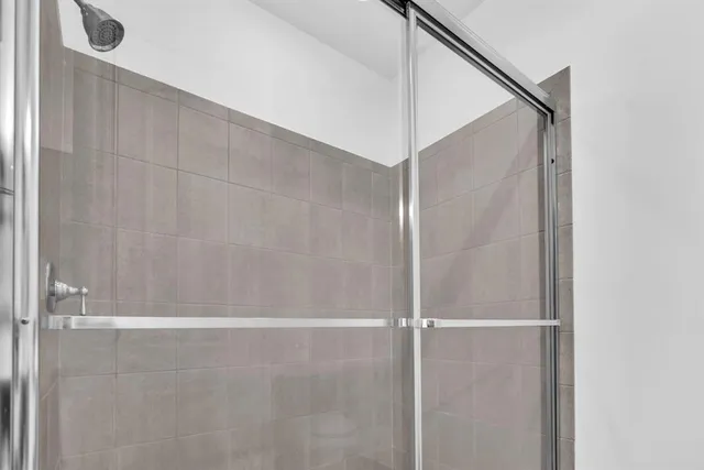a bathroom with a glass shower door