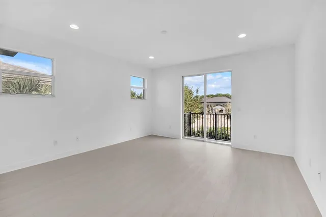 an empty room with windows and closet
