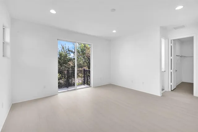 an empty room with large windows