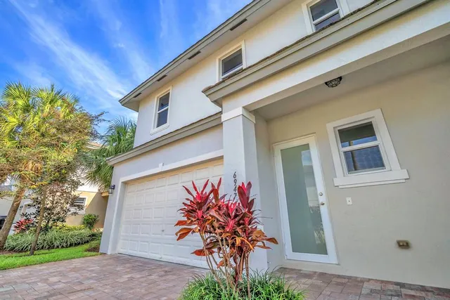 a front view of a house with plants