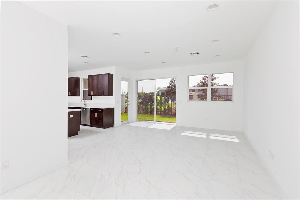 6947 Pines Circle, Unit 21 Pompano Beach, FL 33073 - Photo 5 of 31 an empty room with windows