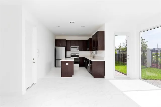 a kitchen with stainless steel appliances a refrigerator and a sink
