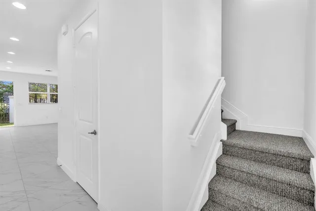 a view of entryway with white walls and stairs