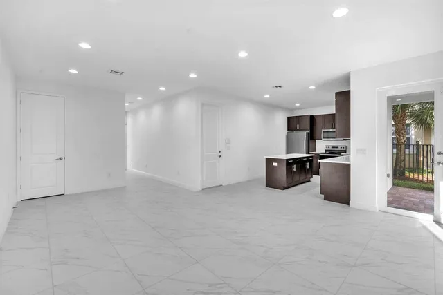a kitchen with stainless steel appliances a refrigerator and a sink