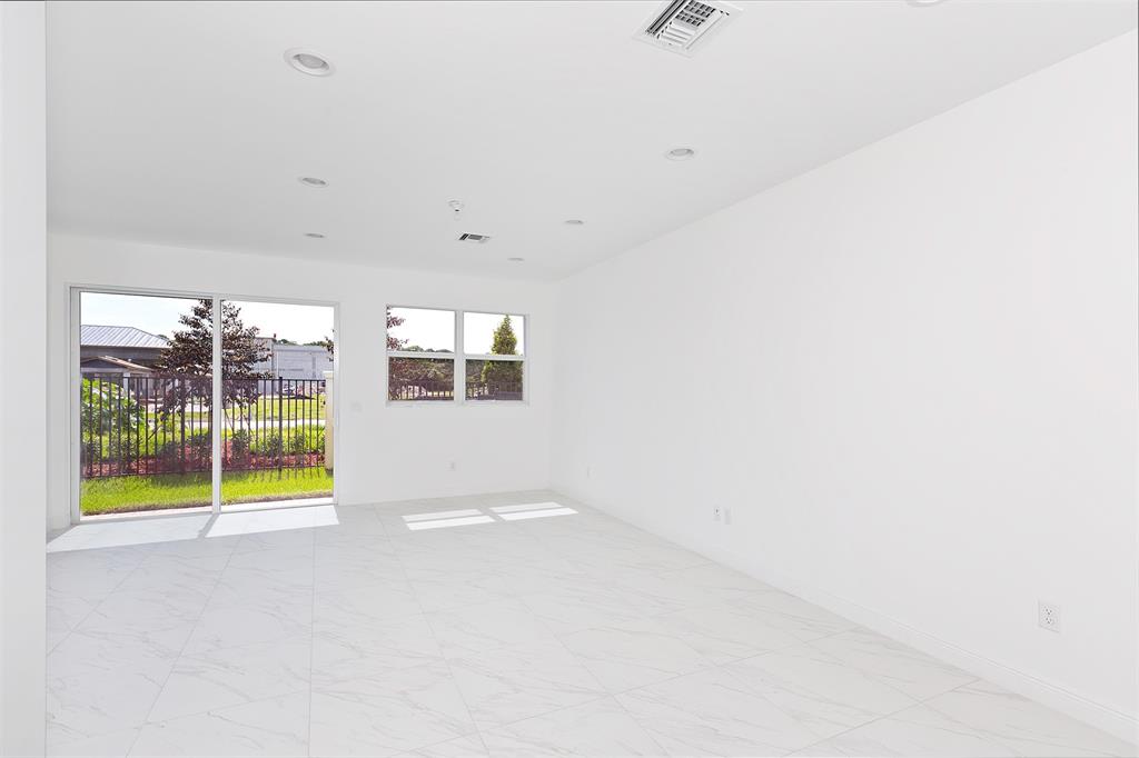 6947 Pines Circle, Unit 21 Pompano Beach, FL 33073 - Photo 10 of 31 a view of an empty room with a window