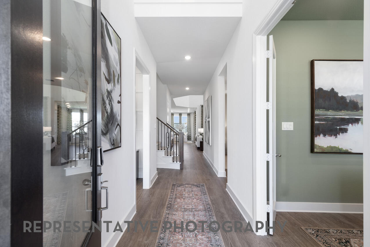 1216 Wolf Cyn Road Georgetown, TX 78628 - Photo 30 of 39 a view of a hallway with wooden floor and staircase