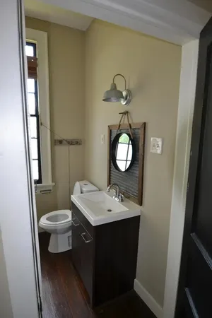 a bathroom with a toilet sink and mirror