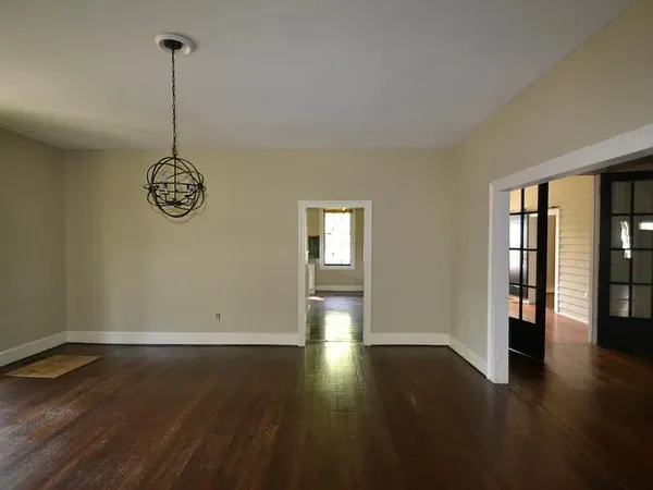 a view of a room with wooden floor and windows
