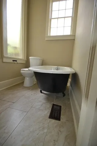 a room with a chair and window