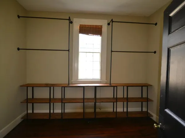 a view of a bathroom with a window and a refrigerator