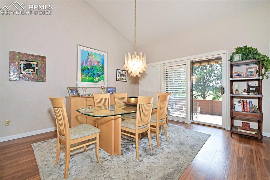 3670 Camels Ridge Lane Colorado Springs, CO 80904 - Photo 11 of 22 a dining room with furniture a book and wooden floor