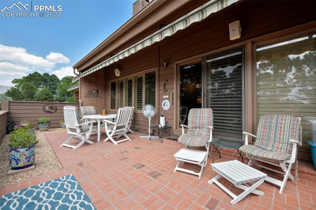 3670 Camels Ridge Lane Colorado Springs, CO 80904 - Photo 14 of 22 a view of a patio with a table and chairs