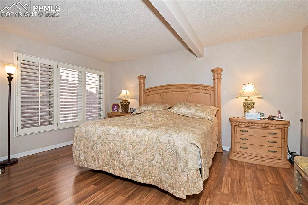 3670 Camels Ridge Lane Colorado Springs, CO 80904 - Photo 15 of 22 a bed sitting in a bedroom next to a window and lamp