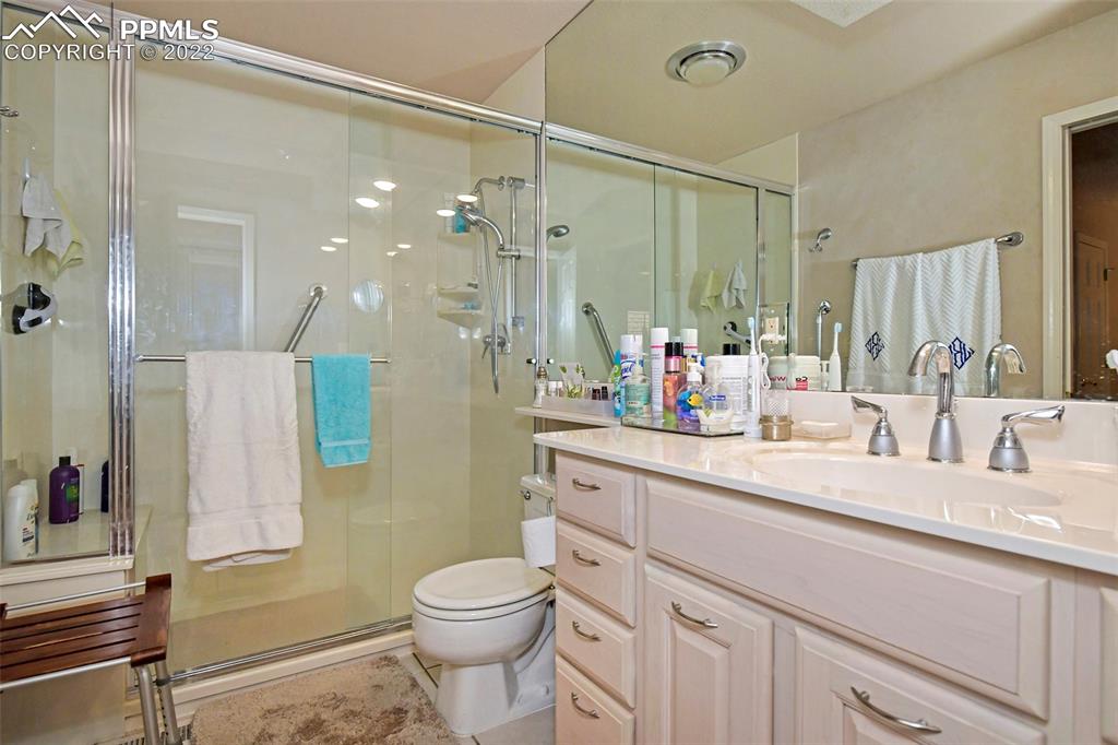3670 Camels Ridge Lane Colorado Springs, CO 80904 - Photo 18 of 22 a bathroom with a sink a toilet and shower