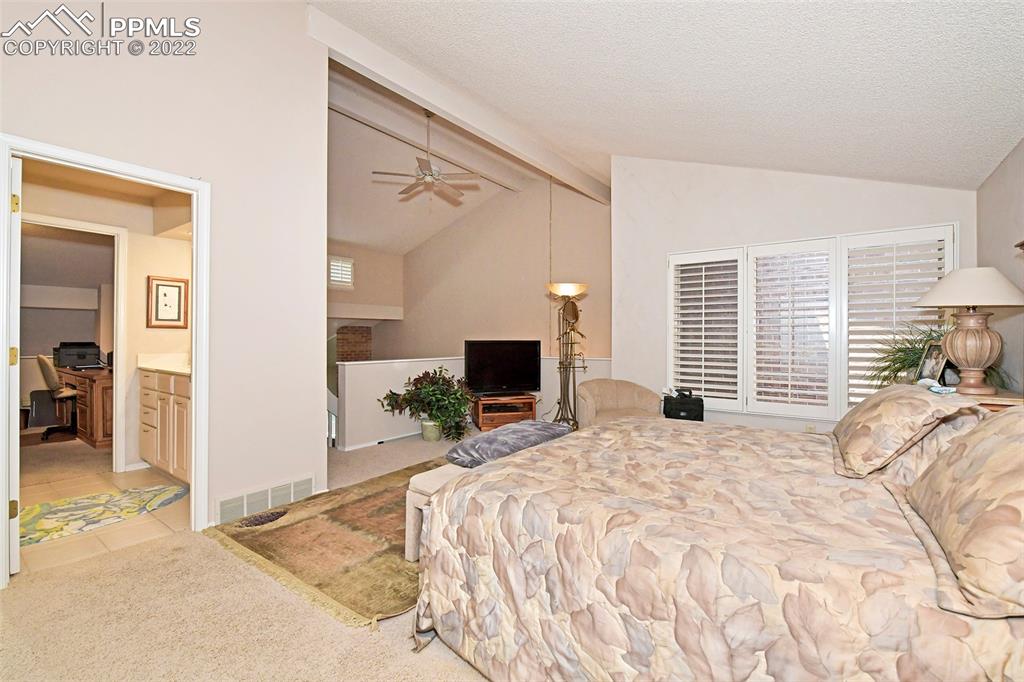 3670 Camels Ridge Lane Colorado Springs, CO 80904 - Photo 19 of 22 a bedroom with a bed and a flat screen tv
