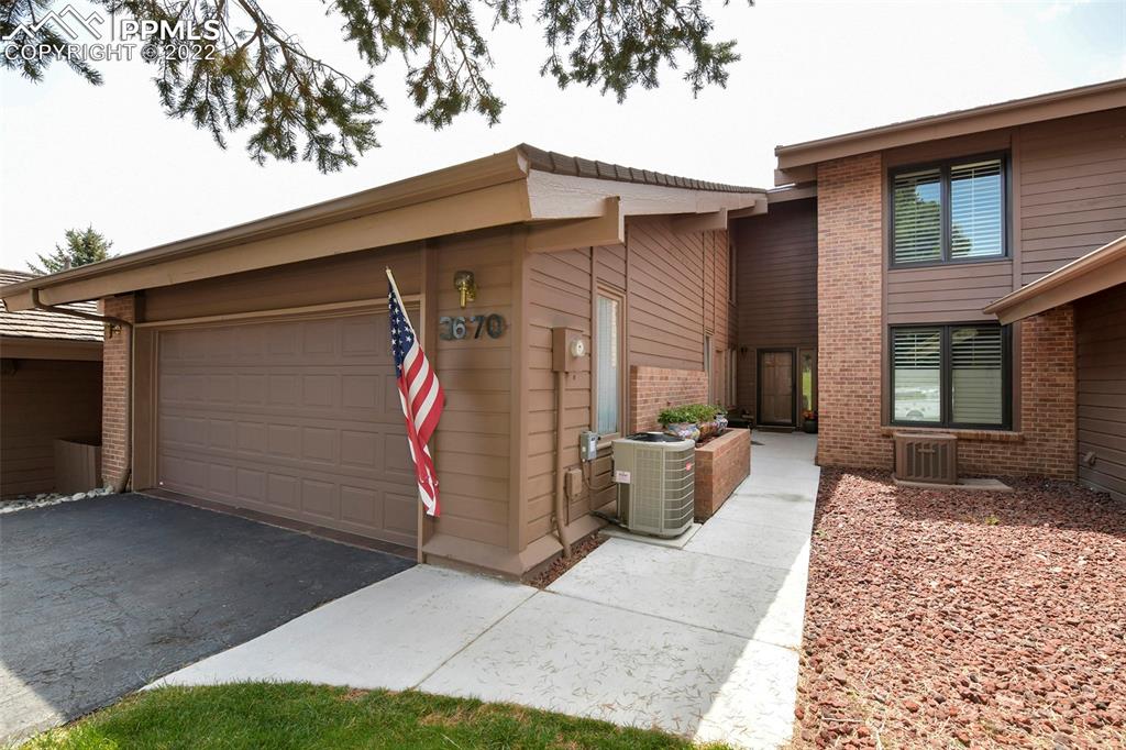 3670 Camels Ridge Lane Colorado Springs, CO 80904 - Photo 3 of 22 a view of a house with barbeque grill and wooden fence