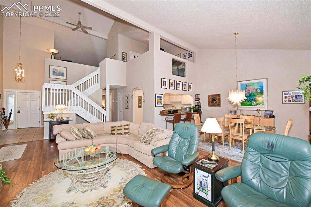 3670 Camels Ridge Lane Colorado Springs, CO 80904 - Photo 4 of 22 a living room with furniture kitchen view and a wooden floor