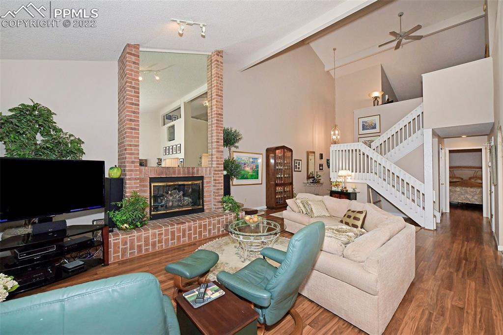 3670 Camels Ridge Lane Colorado Springs, CO 80904 - Photo 6 of 22 a living room with fireplace furniture and a flat screen tv