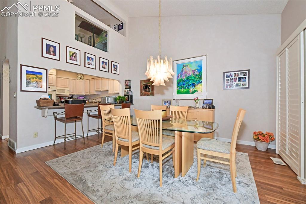 3670 Camels Ridge Lane Colorado Springs, CO 80904 - Photo 10 of 22 a dining room with a wooden table and chairs