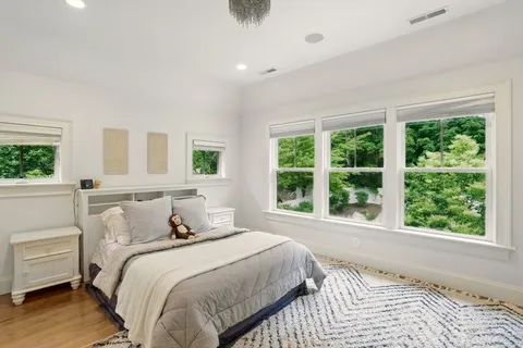a bedroom with a large bed and a large window