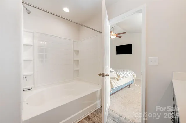 a bathroom with a bathtub and a shower