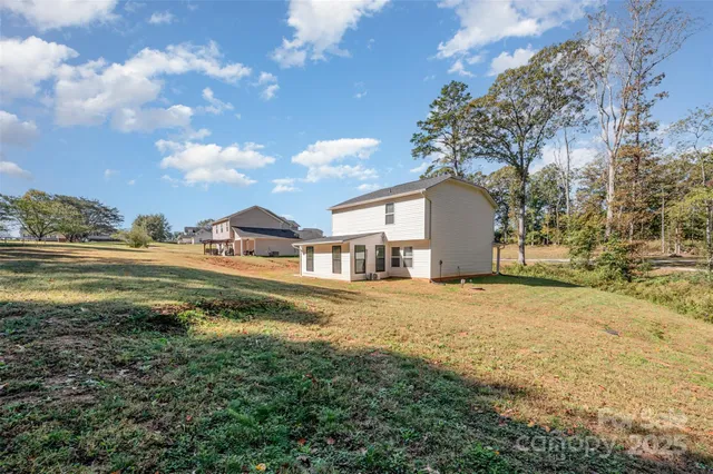 a house view with a swimming pool next to a yard