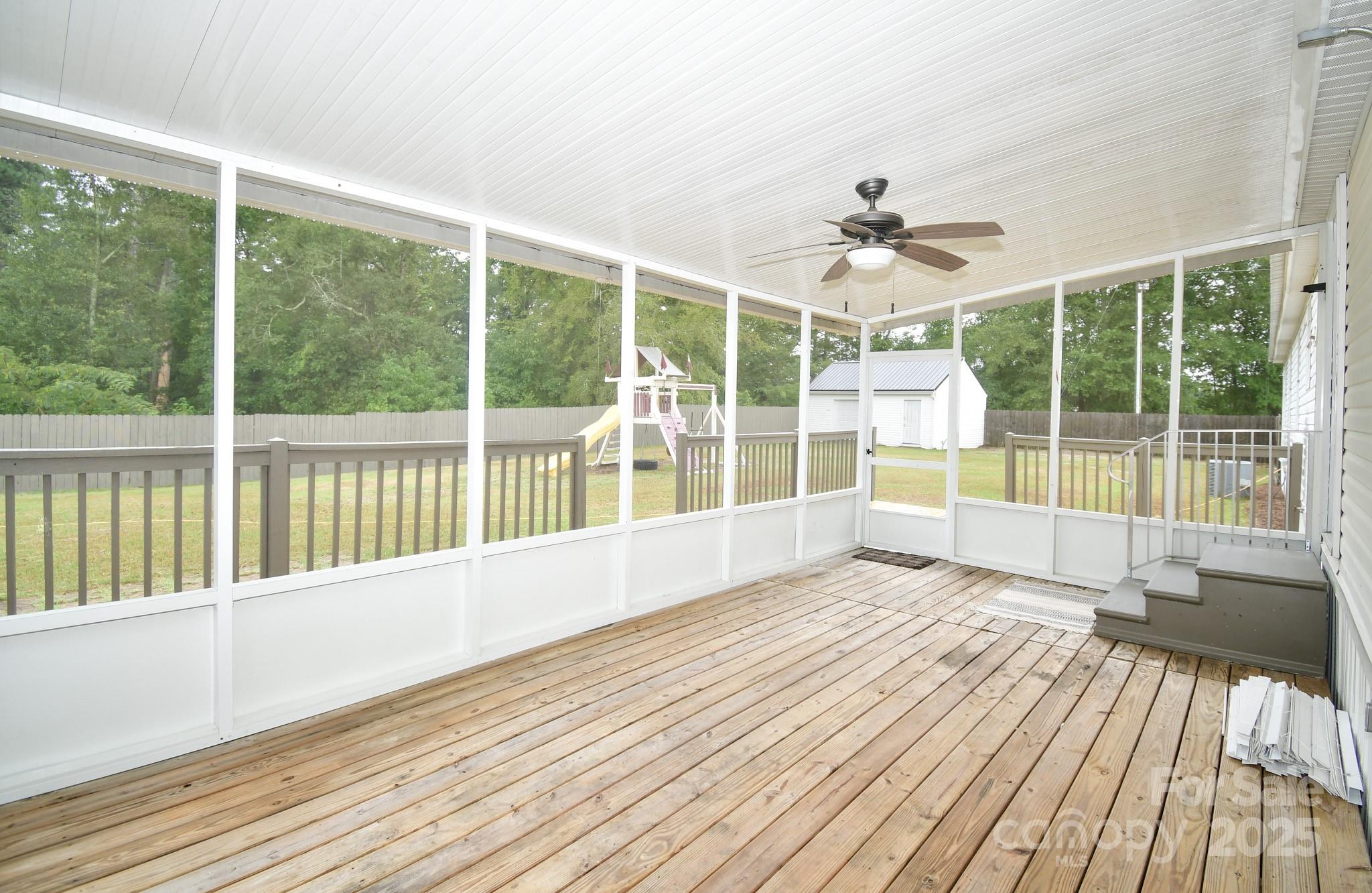 9552 Flat Creek Road Kershaw, SC 29067 - Photo 11 of 47 a view of an empty room with wooden floor and a large window