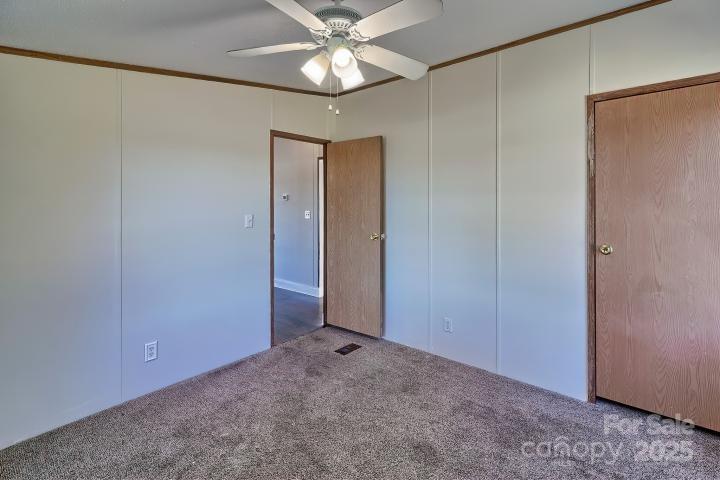 9552 Flat Creek Road Kershaw, SC 29067 - Photo 15 of 47 an empty room with a ceiling fan and a window