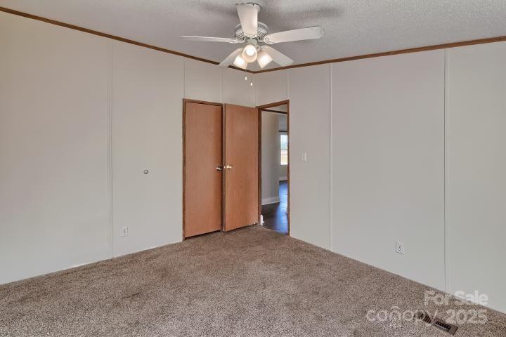 9552 Flat Creek Road Kershaw, SC 29067 - Photo 17 of 47 an empty room with a chandelier fan and closet