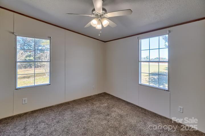 9552 Flat Creek Road Kershaw, SC 29067 - Photo 18 of 47 an empty room with windows and fan