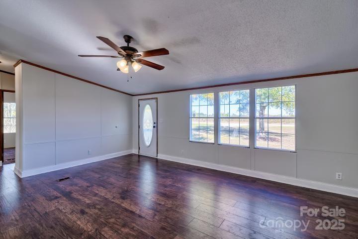 9552 Flat Creek Road Kershaw, SC 29067 - Photo 22 of 47 a view of an empty room with window and wooden floor