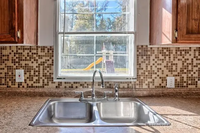 a kitchen with a sink and a window