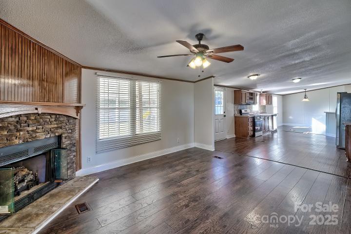 9552 Flat Creek Road Kershaw, SC 29067 - Photo 31 of 47 a view of an empty room with a fireplace and a window