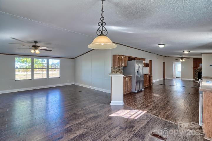 9552 Flat Creek Road Kershaw, SC 29067 - Photo 32 of 47 a view of a room with wooden floor chandelier and windows