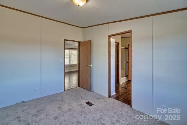 an empty room with windows and closet