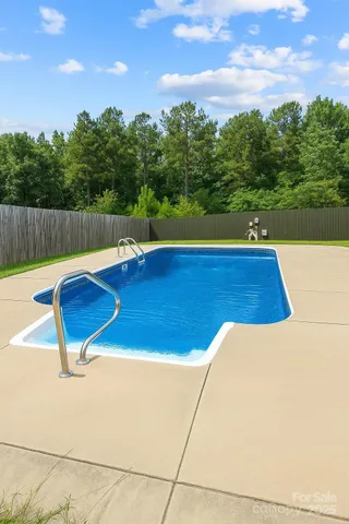 a view of a swimming pool with a yard