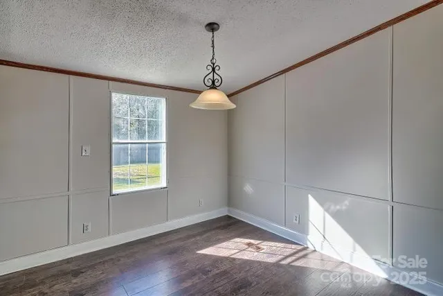 a view of a room with window and wooden floor