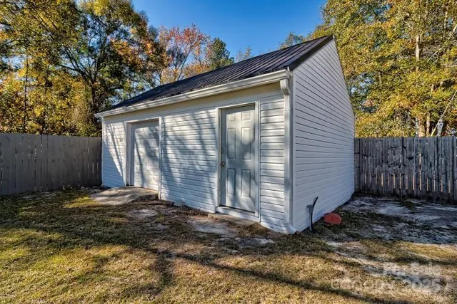 a view of a backyard with a large tree