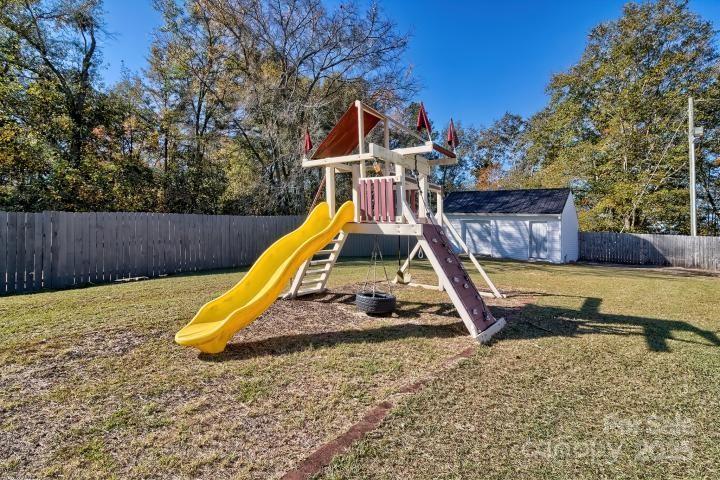 9552 Flat Creek Road Kershaw, SC 29067 - Photo 45 of 47 a view of a backyard with a slide and wooden fence