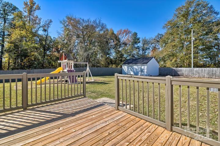 9552 Flat Creek Road Kershaw, SC 29067 - Photo 47 of 47 a view of a wooden deck and a yard with swimming pool